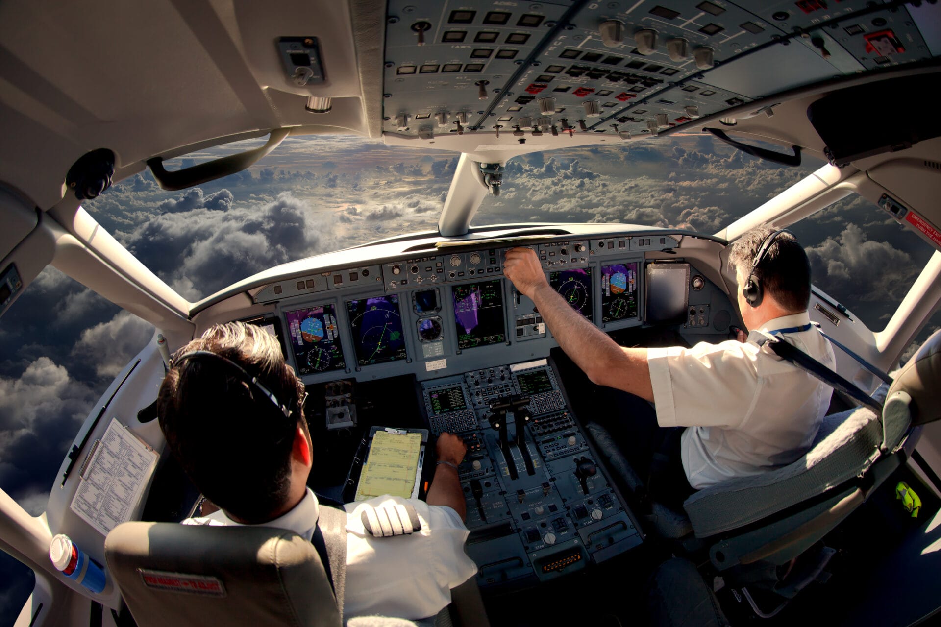 Two pilots inside a cockpit during flight, showcasing the role of eye-tracking technology in monitoring gaze behavior and improving aviation safety.