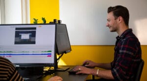 A researcher conducting a human behavior study using multimodal biometric software, analyzing visual attention and engagement on a computer screen