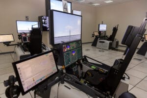 Security control room with wall-to-wall surveillance monitors, an example of a complex multi-screen setup where eye tracking can study attention and situational awareness.