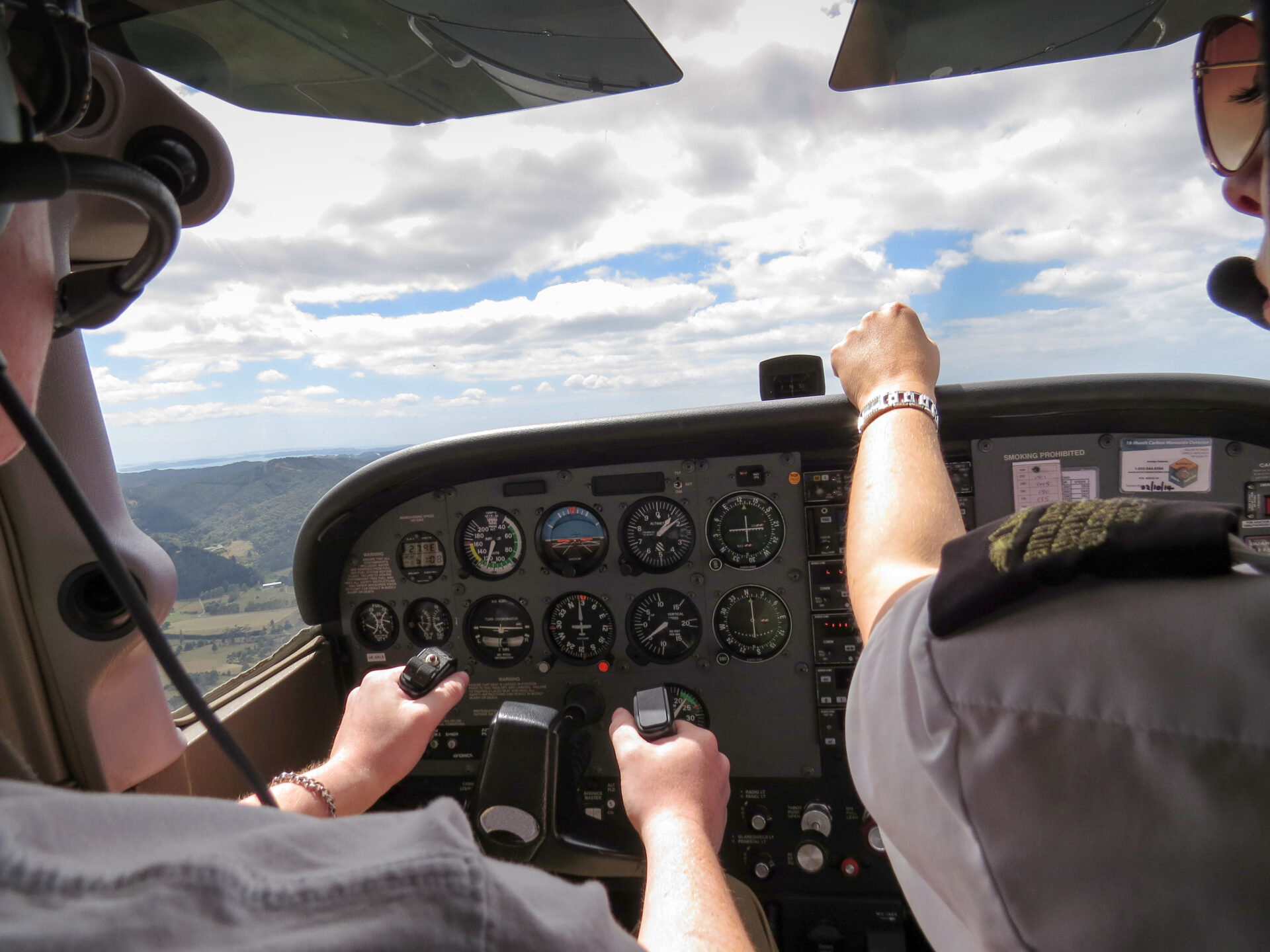 Pilots in a cockpit simulator monitoring instruments during flight training, illustrating visual attention, scanning behavior, and situational awareness.