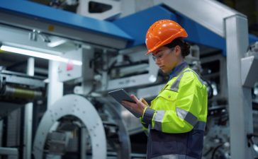 Engineer looking tablet computer in energy company
